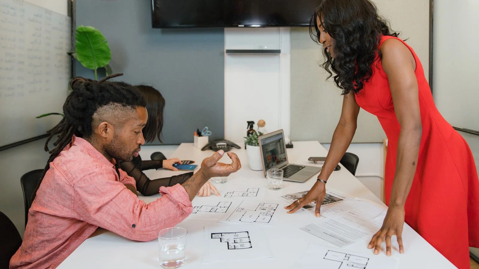 Business professionals engaged in a collaborative office meeting, discussing project plans