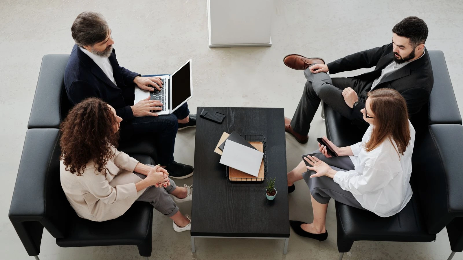 Professional team meeting in modern office setting with colleagues discussing a project